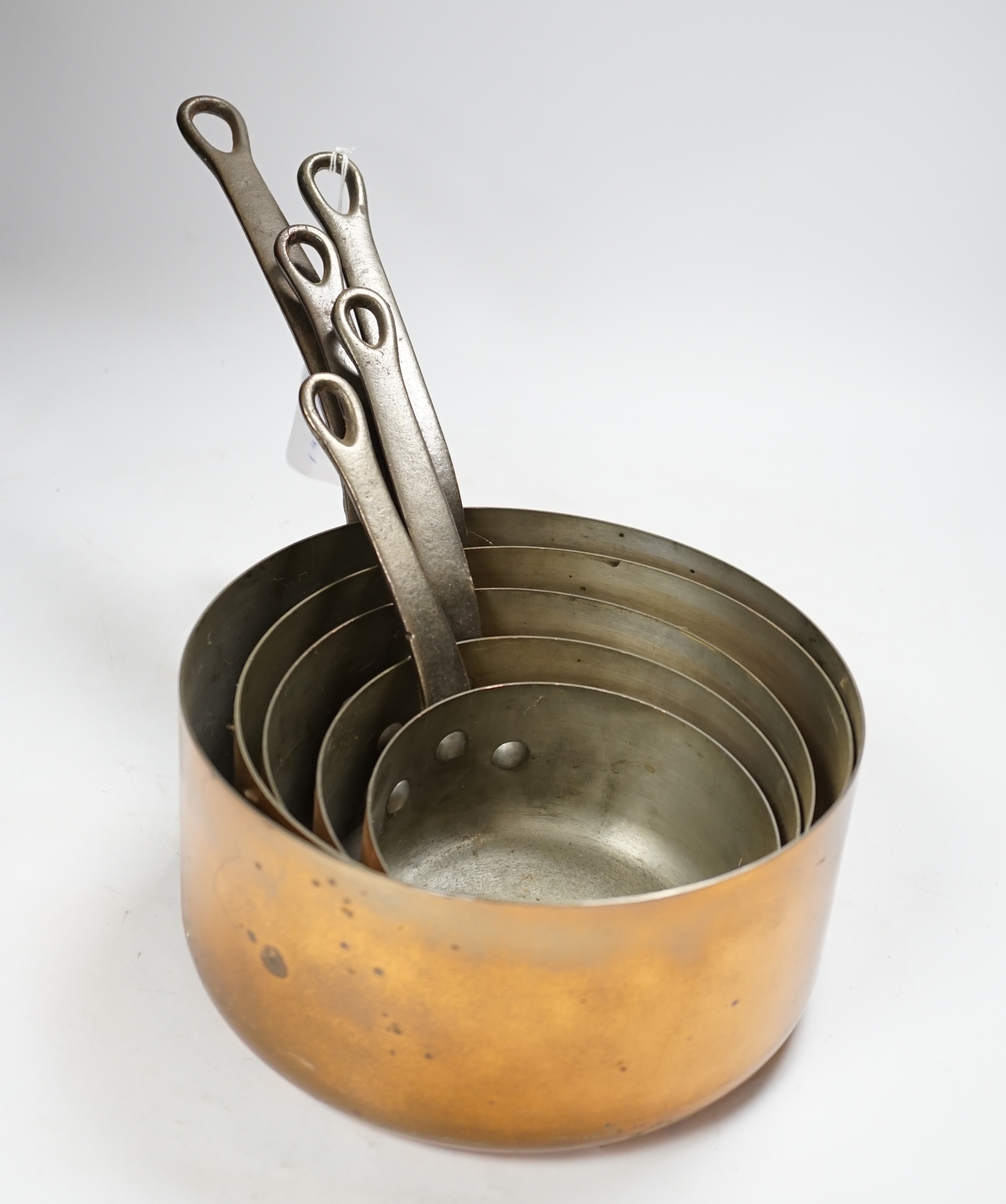 A set of five French graduated copper saucepans, signed Faucogney